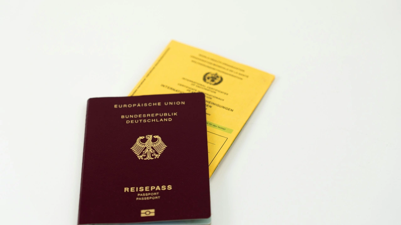 A maroon German passport (Reisepass) with gold lettering and the federal eagle crest, resting on top of a yellow International Certificate of Vaccination (WHO