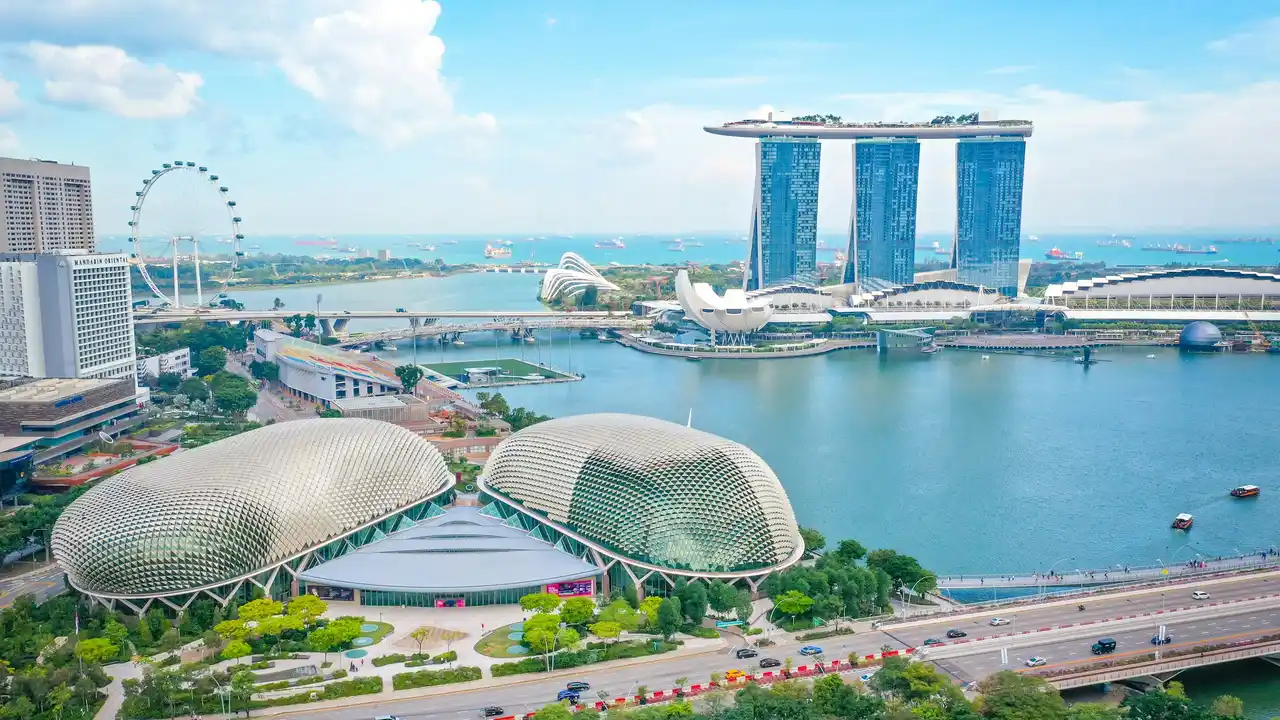 Singapore skyline featuring Marina Bay Sands, Singapore Flyer, and Esplanade Theatres by the Bay overlooking Marina Bay waterfront