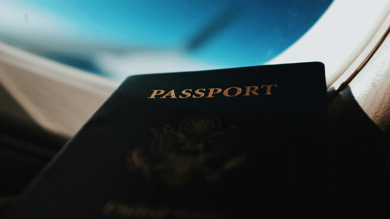 A close-up, low-angle shot of the cover of a dark blue passport with the word