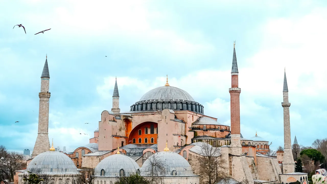 Hagia Sophia Istanbul landmark with grand dome and minarets under blue sky popular tourist attraction in Turkey