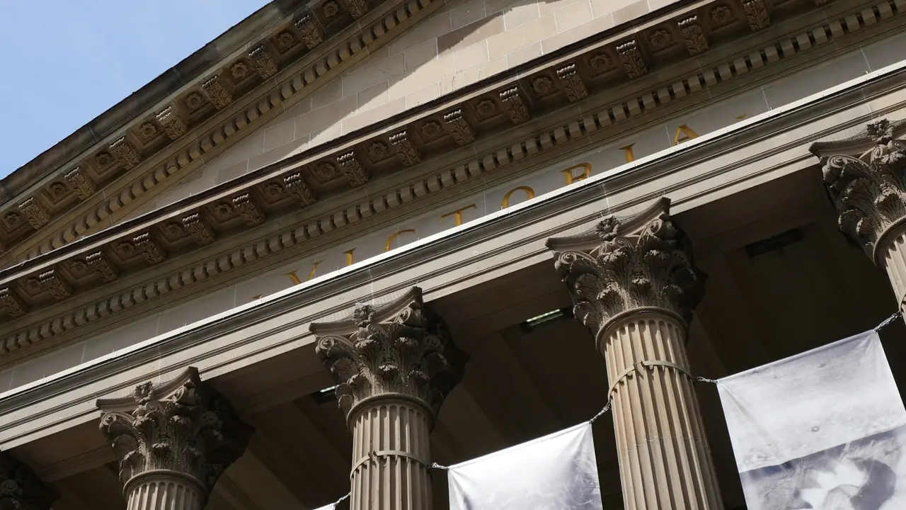 Neoclassical façade of the Hungarian National Museum (Magyar Nemzeti Múzeum) in Budapest, featuring ornate Corinthian columns and historic architectural details under a clear sky.
