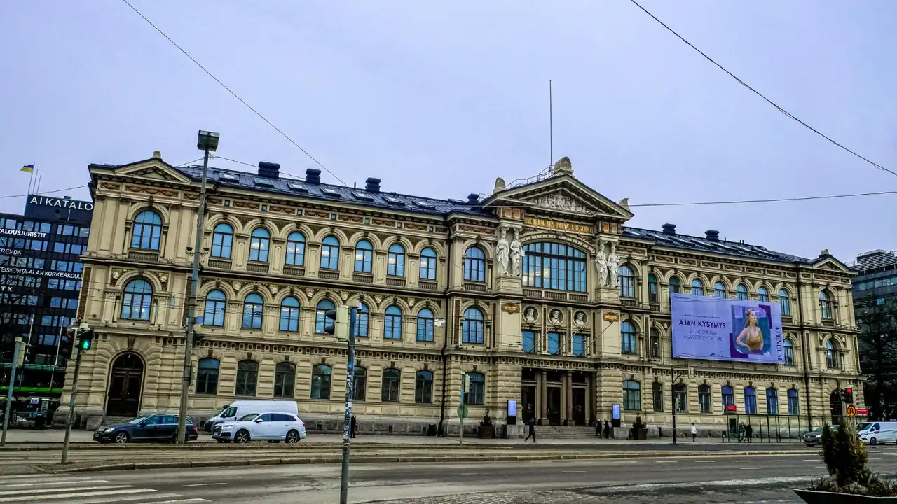 Ateneum Art Museum historic neoclassical building in Helsinki, Finland, with ornate façade, arched windows, and street view along Mannerheimintie.