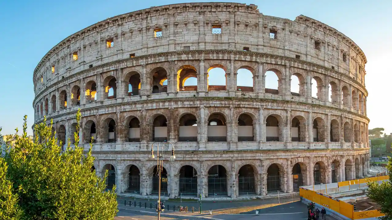 Visit the Colosseum in Rome, Italy – iconic ancient Roman amphitheater with massive stone arches, a top historical landmark and must-see tourist attraction.