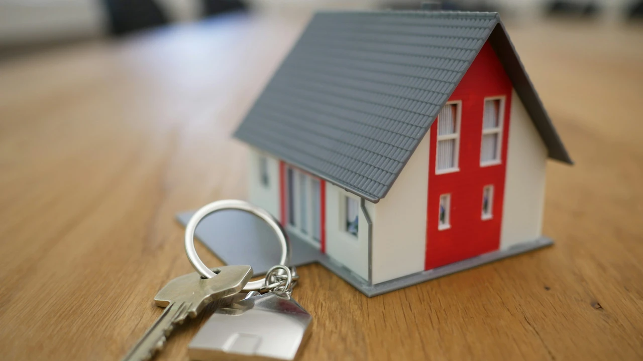 House model with keys placed on a table symbolizing eligibility, timing, and application process for permanent residence and long-term residency.