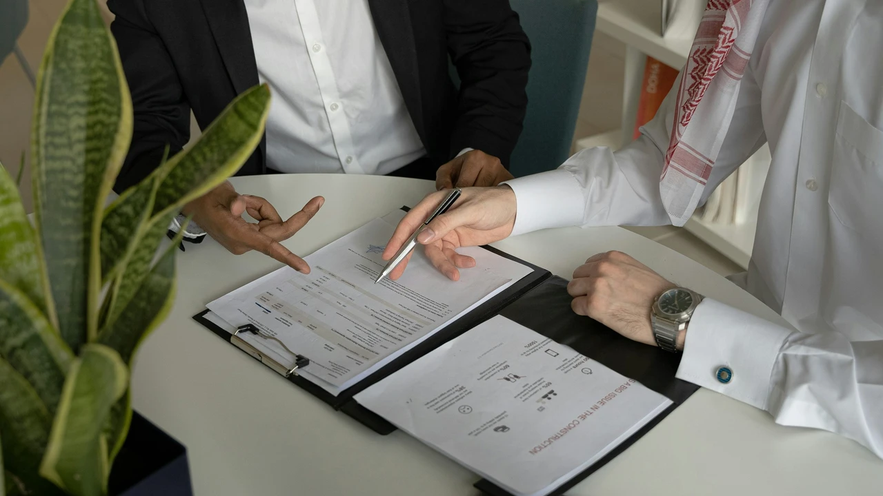 Visa consultation meeting at an office where applicants review and sign documents with an immigration advisor, illustrating key steps in the Hungary visa application process at the embassy for Pakistani applicants.