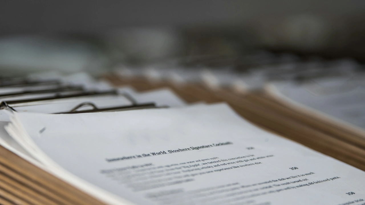 Stack of visa application documents and paperwork organized in folders on a desk, representing the visa application and immigration process.