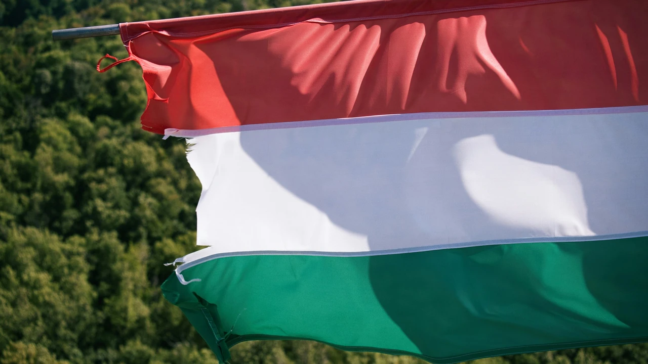 Hungarian national flag with red, white, and green horizontal stripes waving outdoors, symbolizing Hungary, visa types, immigration policies, and travel opportunities for foreign nationals.