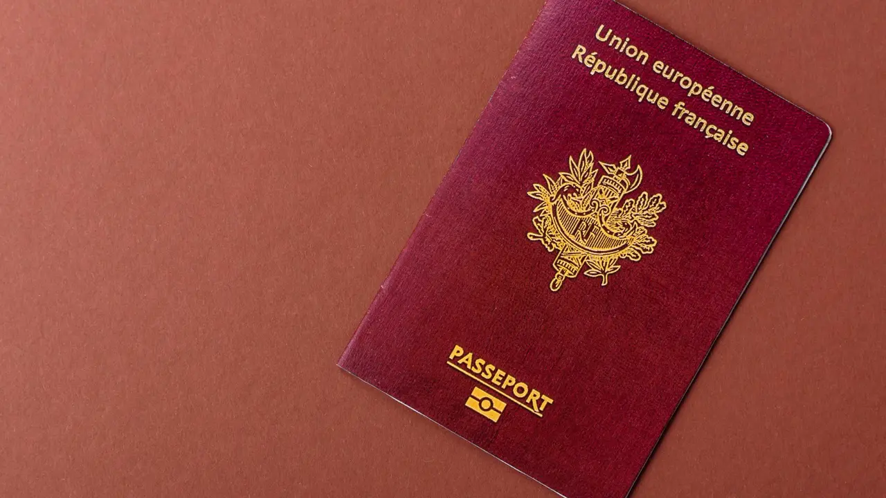 French passport from the European Union (République Française) with gold emblem on red cover, symbolizing France citizenship and international travel documentation