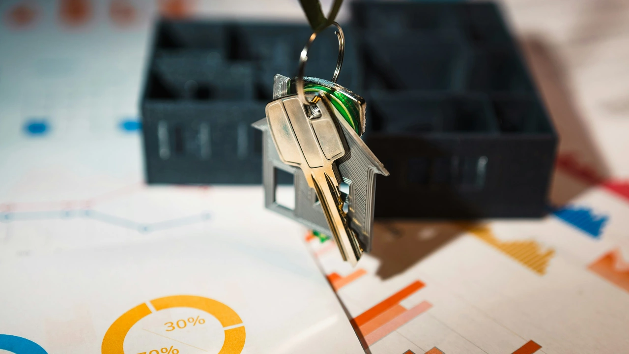 House-shaped keychain with property keys placed over financial charts and documents, representing property ownership documents used as proof of assets for visa or financial applications.