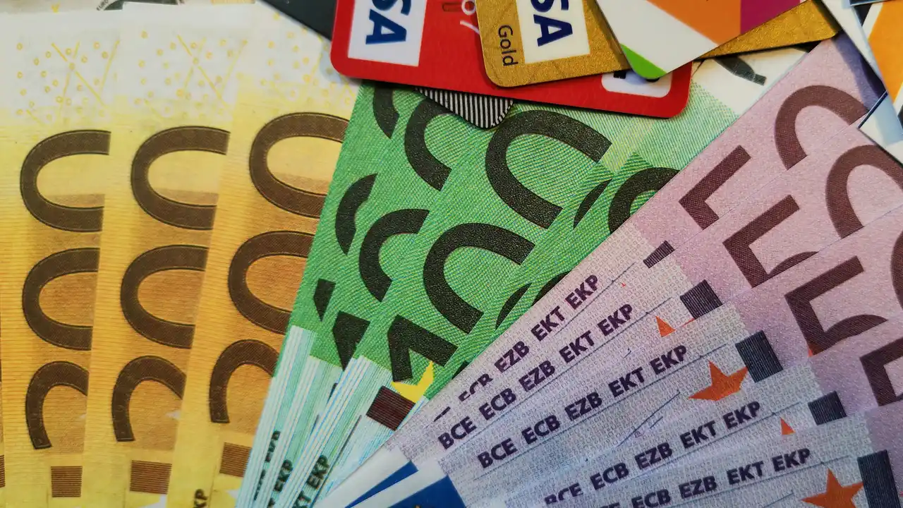 Euro banknotes and credit cards close up representing European currency finance banking and international payment transactions