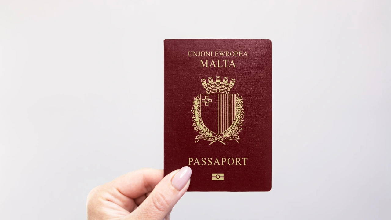 Hand holding a Malta passport with European Union emblem, official Maltese biometric travel document isolated on light background
