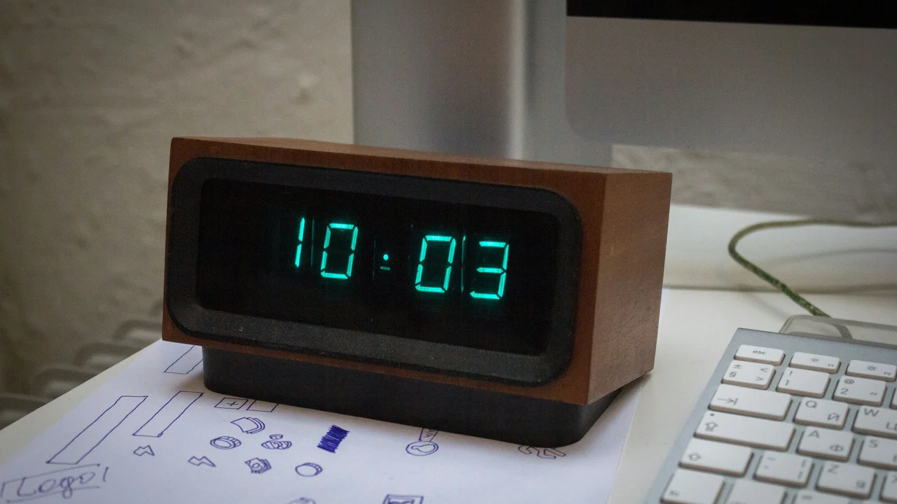Digital desk clock showing time on a work desk, representing Finland visa application processing time and waiting period.