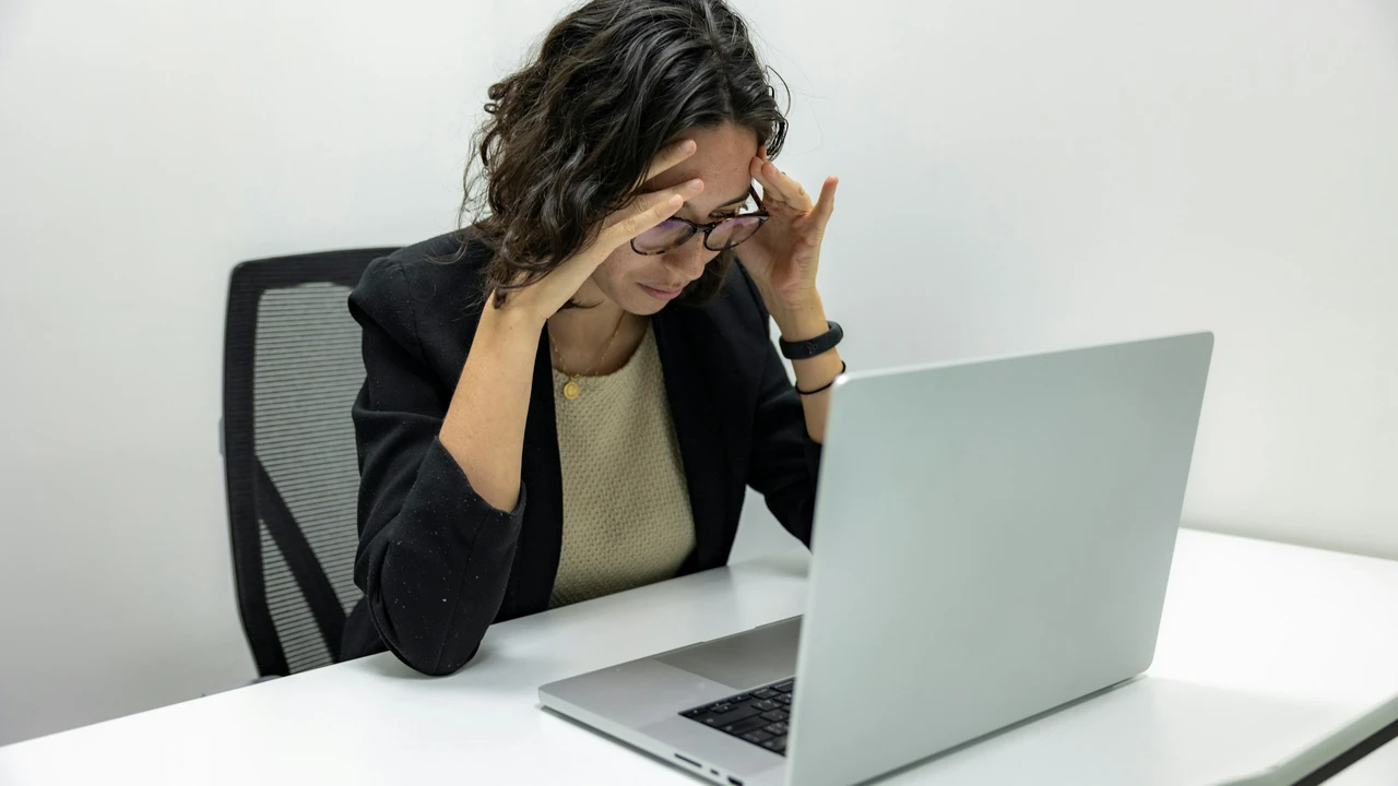 Stressed woman reviewing online visa application on laptop – Schengen visa process and travel document submission concept.