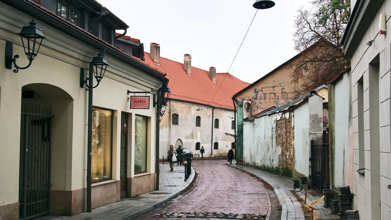 Historic old town street in Lithuania with traditional architecture and cobblestone road, representing travel and Lithuania visa requirements.