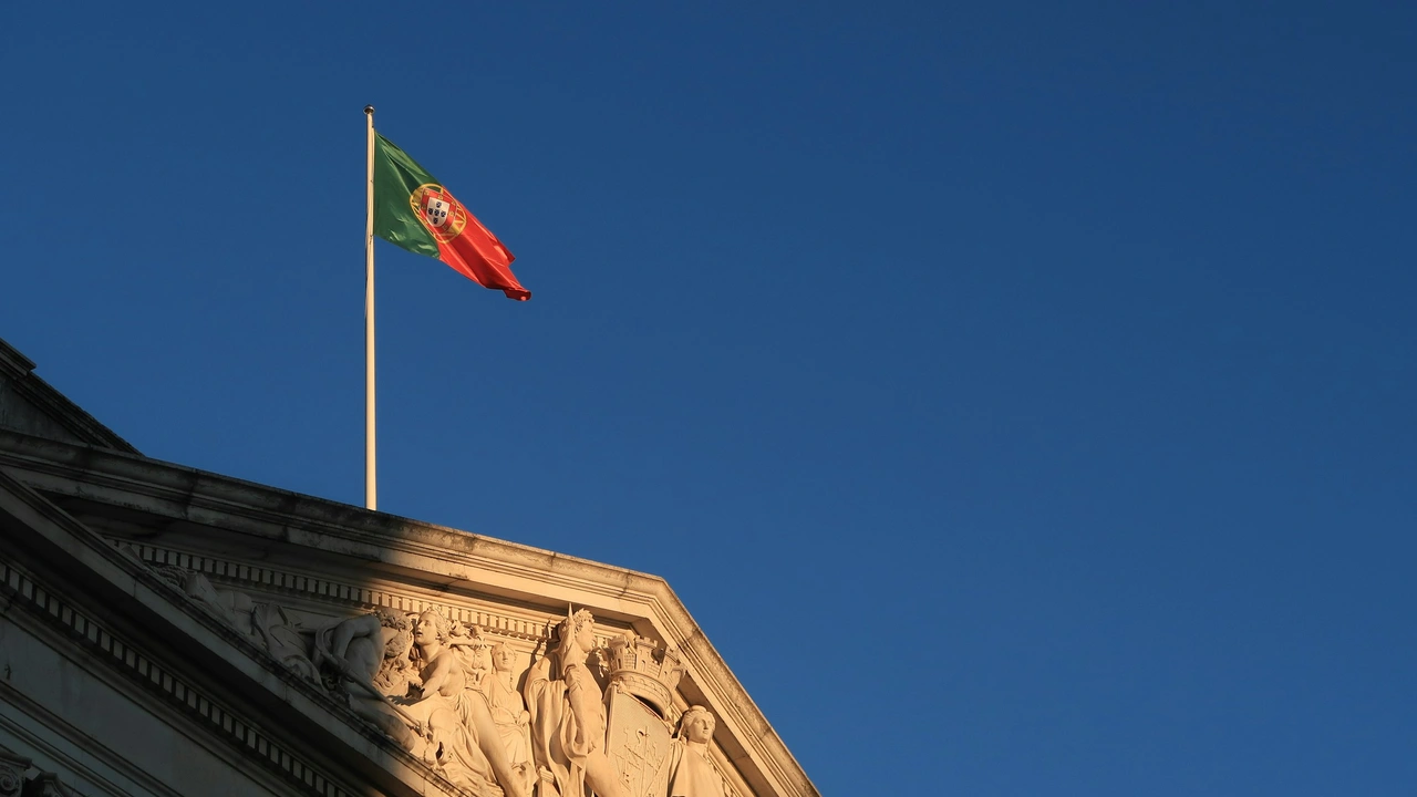Portuguese national flag flying above a historic government building against a clear blue sky, representing the Portugal Honorary Consulate and official diplomatic presence in Chennai, India.