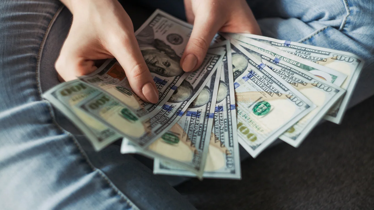 Step 3 deposit visa fee and book a visa appointment showing applicant holding cash for visa application payment and appointment booking process.