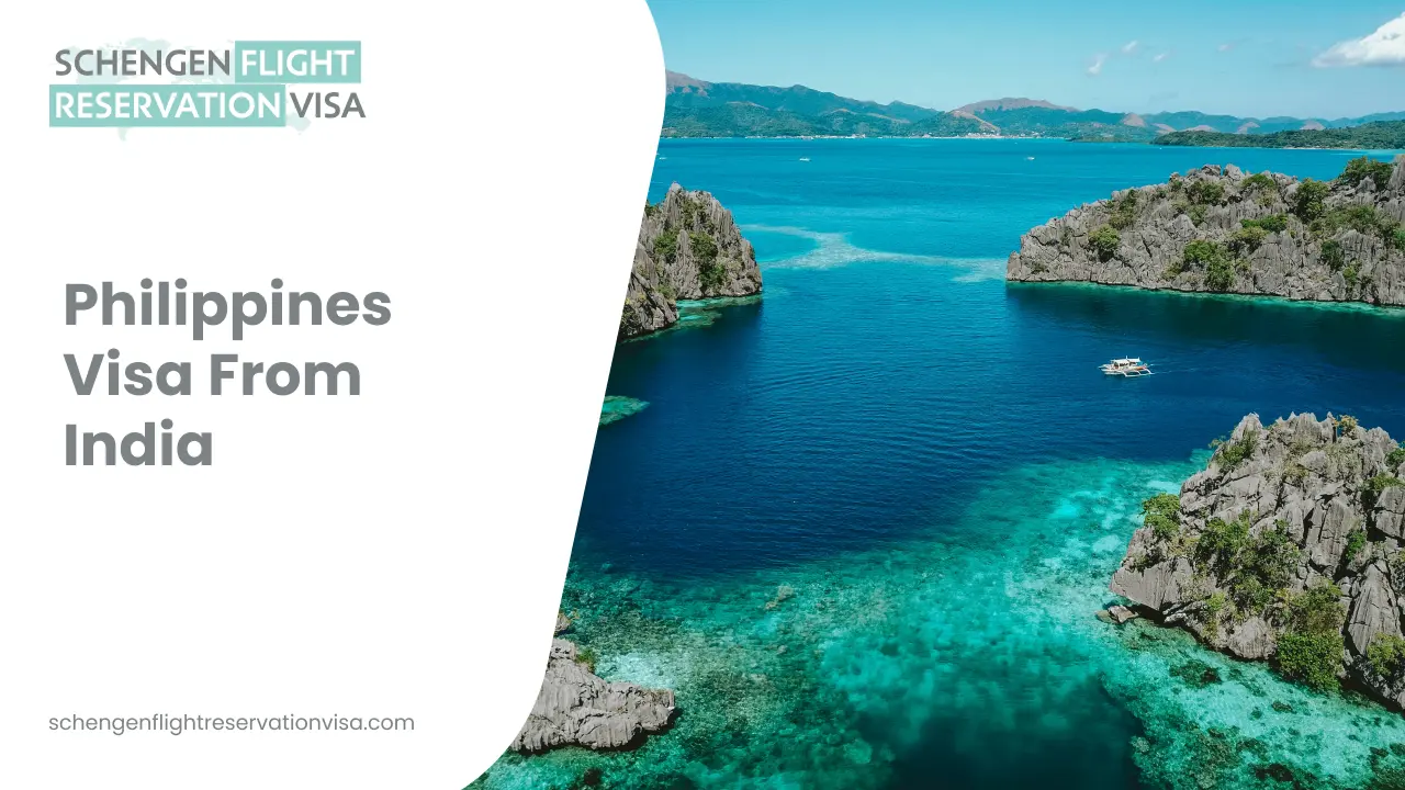 An aerial, wide-angle view of a tropical coastline in the Philippines, featuring clear turquoise waters and dramatic limestone cliffs rising from the sea. A small white boat is visible in the bay, surrounded by lush green islands and mountains under a bright blue sky.