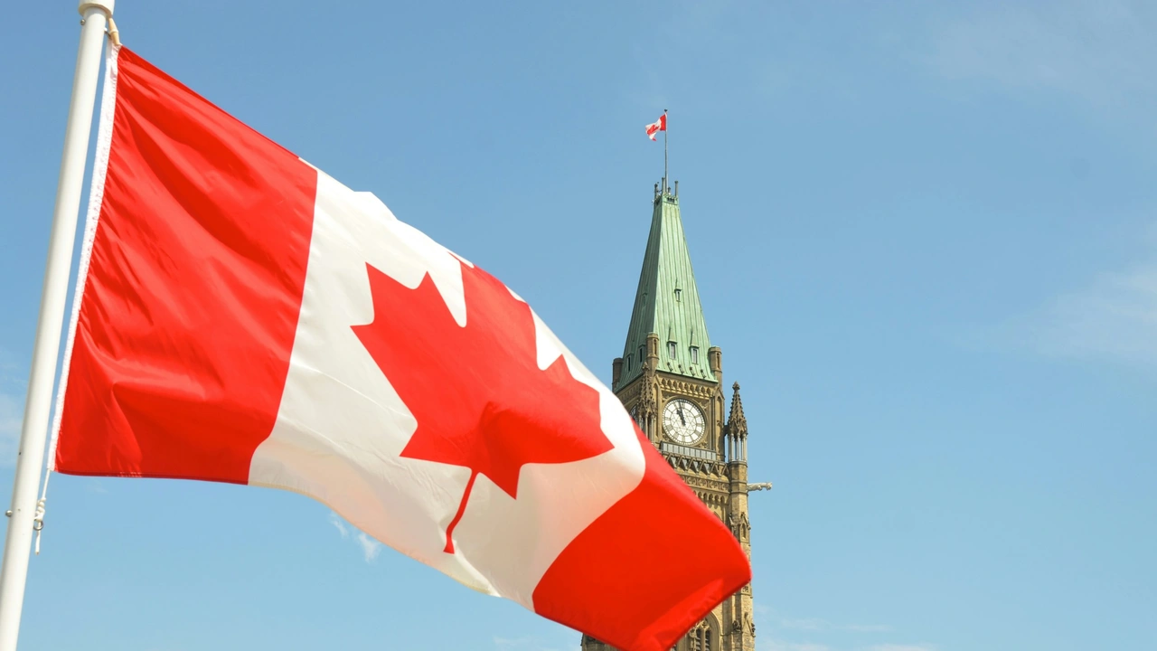 Canadian flag waving in front of the Parliament Building in Ottawa, representing Canada business visa and immigration process