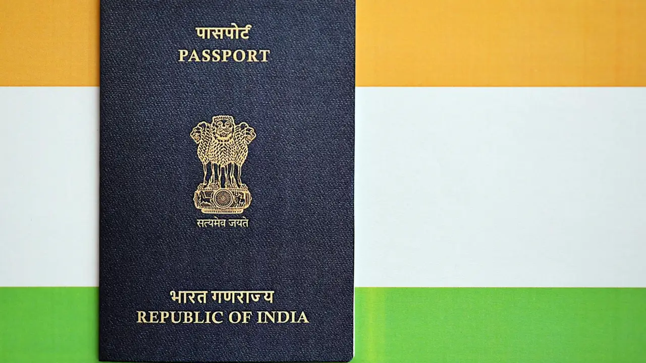 Indian passport with national emblem placed against the Indian tricolor flag background, representing Republic of India travel and citizenship document
