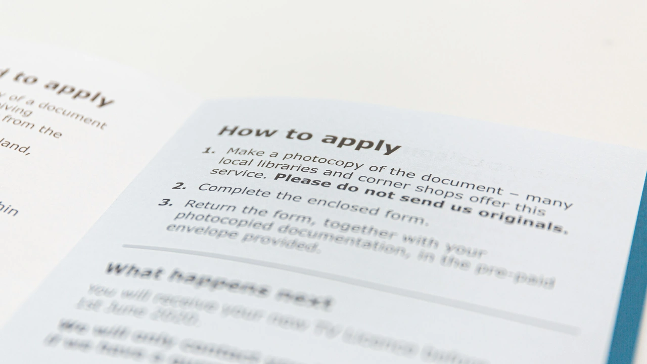 Close up of how to apply instructions document with application steps and submission guidelines on printed form