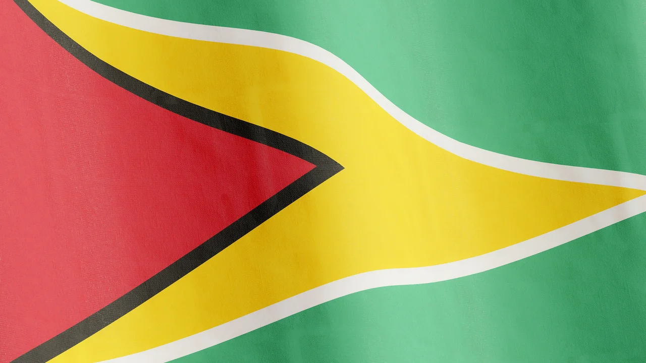 A close-up, full-frame image of the national flag of Guyana, known as