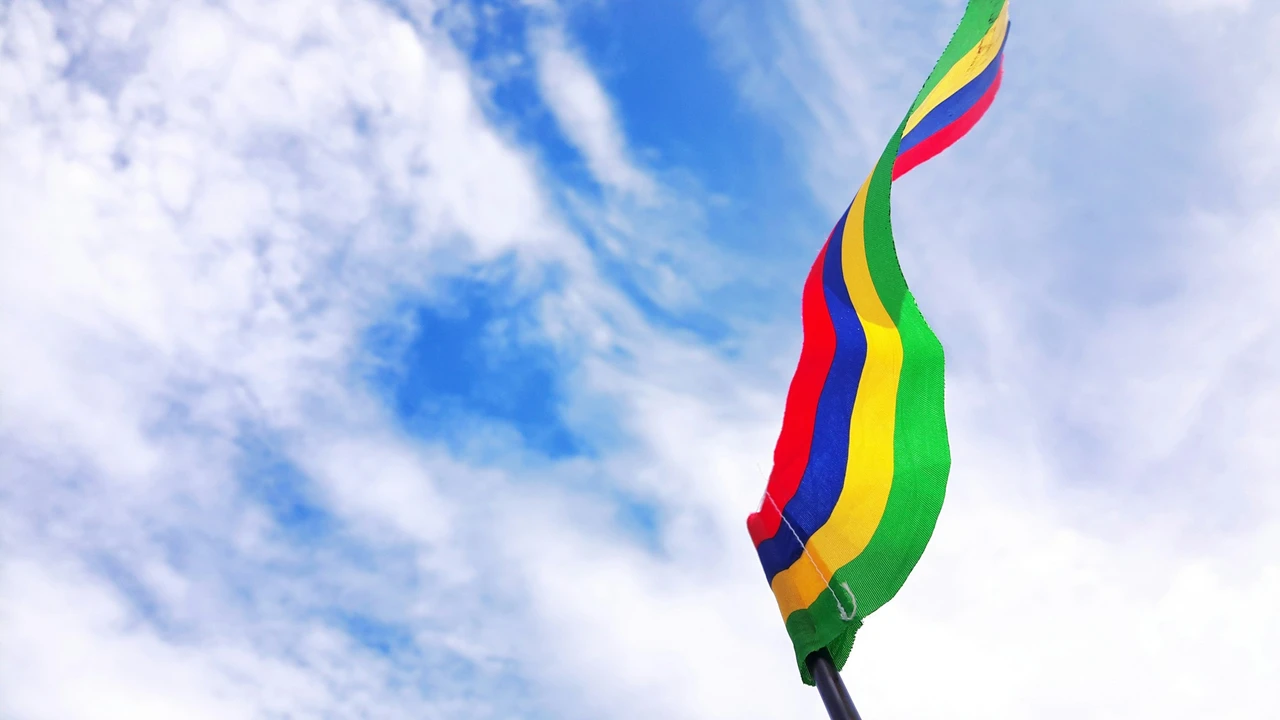 Mauritius flag waving in the sky, symbol of Mauritius travel, tourism, and visa information for Indian travelers