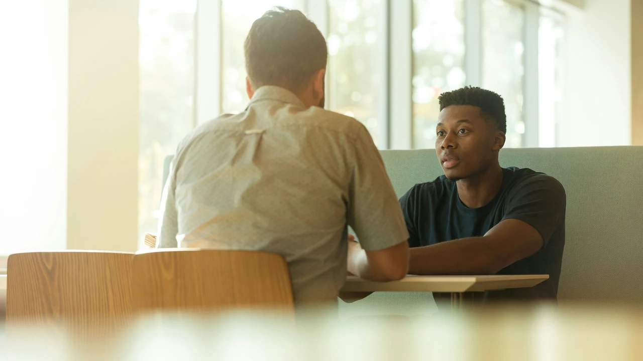 Visa interview meeting between applicant and immigration officer at office desk – professional consultation for Norway Schengen visa application.